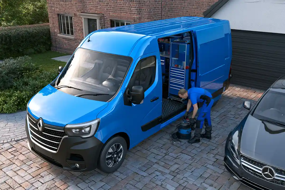 Mobile car repair van beside a customer vehicle